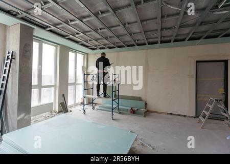 Drywall Installers. Men holding a gypsum board figured cut Stockfoto