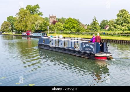 Ein langes Boot auf dem Gloucester und dem Sharpness Canal vorbei an der St. Marys Kirche an der Splatt Bridge im Dorf Frampton in Severnside auf Severn, Gloucester Stockfoto