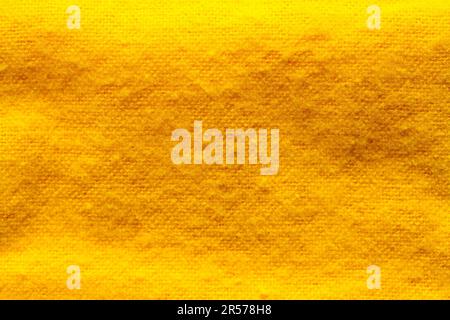 Nahaufnahme des Hintergrunds aus gelbem Baumwollstoff. Stockfoto