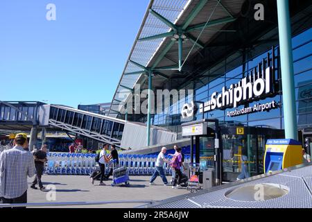 Amsterdam, Niederlande - 10. August 2022: Passagiere, die an einem sonnigen Tag am Flughafen Amsterdam Schiphol einreisen. Stockfoto