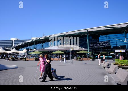 Amsterdam, Niederlande - August 10 2022: Ein Paar zu Fuß vom Flughafen Amsterdam Schiphol an sonnigen Tagen. Stockfoto