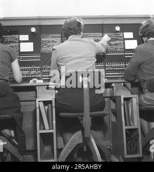 Telefonie in den 1950er. Frauen, die in einer Telefonzentrale arbeiten, als Telefonisten. Ein manuell betriebenes Telefonkommunikationssystem, bei dem die eingehenden Anrufe vom Betreiber weitergeleitet und an eine andere Telefonnummer umgeleitet wurden, in diesem Fall lokal innerhalb des Gebäudes, das ein Unternehmen oder eine Organisation mit vielen internen Telefonleitungen bedient. Die Telefonzentrale konnte Nachrichten entgegennehmen und Sie in die Warteschleife setzen, wenn die Leitung besetzt war. Schweden 1953. Kristoffersson Ref. BM99-5 Stockfoto