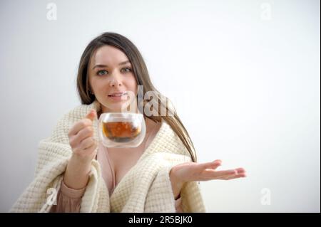 Positive amerikanische Unternehmerin Hold Becher Getränkepunkt Zeigefinger Werbespots Werbeaktion Kleidung karierte Jacke Blazer Anzug isolierte pinkfarbene Pastelltöne Hintergrund. Hohe Qualität Stockfoto