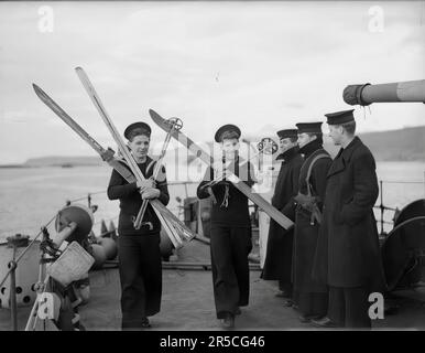 Die Royal Navy während des Zweiten Weltkriegs haben zwei Seeleute, beide ehemalige Wintersportbegeisterte, die Erlaubnis, ihre Skier mit an Bord ihres Schiffes HMS ASHANTI zu nehmen Stockfoto