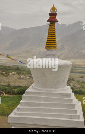 Ein weißer Stupa mit einem wunderschönen Padum (Zanskar-Tal) im Hintergrund. Stockfoto