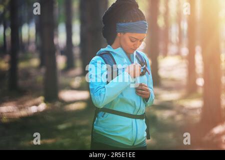 Das beste Projekt, an dem du je gearbeitet hast, bist du. Eine sportliche junge Frau, die im Wald joggen geht. Stockfoto