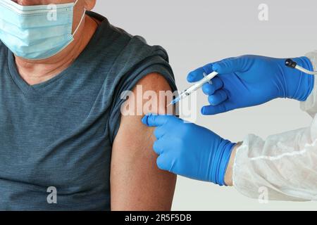 Arzt Impfend Seniorenmensch In Der Klinik. Impfung Älterer Menschen. Gabe von COVID19, Grippe, MPOX Coronavirus-Impfstoff Injektion für Mature 60s Männlich. Gesicht Stockfoto