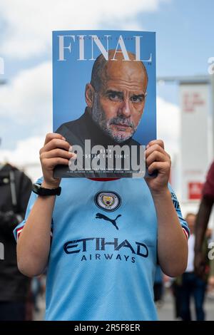 London, Großbritannien. 3. Juni 2023 Ein Manchester City-Fan hält das offizielle Programm ab, mit Manager Pep Guardiola auf dem Cover, vor dem FA-Cup-Finale zwischen Manchester City und Manchester United im Wembley Stadium. Aus Gründen der Sicherheit der Menschenmenge wurde in diesem Gebiet ein Alkoholverbot verhängt. Kredit: Stephen Chung / Alamy Live News Stockfoto