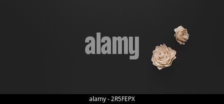 Herbstzusammensetzung mit getrockneten weißen Rosen auf dunklem Hintergrund. Flacher Kopierbereich. Stockfoto