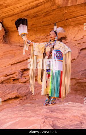 Eine amerikanische Navajo-Frau im Honeymoon Arch im Mystery Valley im Monument Valley Navajo Tribal Park, Arizona, USA Stockfoto