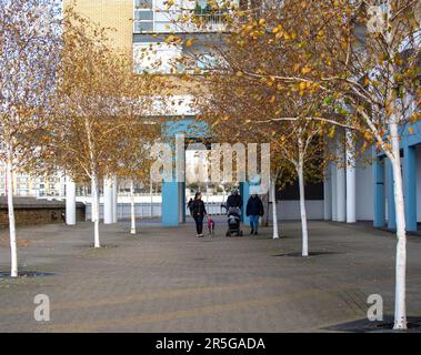 London, Großbritannien - November 18 2020: Im Herbst spazieren die Menschen entlang des Flussufers an der Themse auf der Isle of Dogs in der Nähe von Canary Wharf. Stockfoto