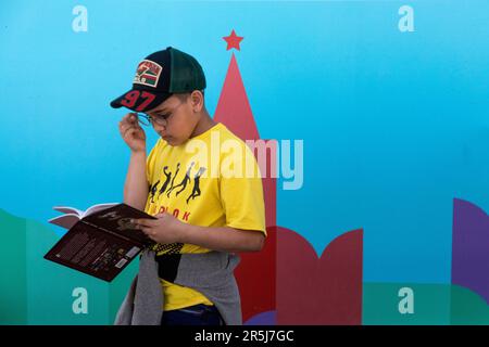 Moskau, Russland. 2. Juni 2023. Ein Kind liest ein Buch auf der 9. Ausgabe des jährlich stattfindenden Red Square Book Festivals in Moskau, Russland Stockfoto