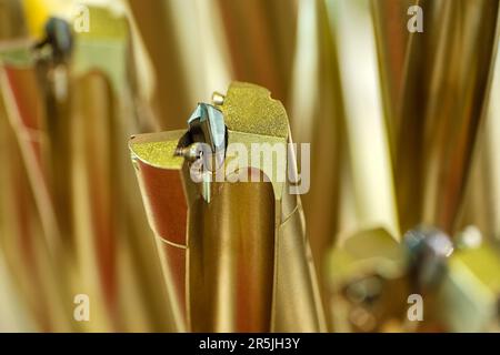 Spiralbohrer für Metallbearbeitungswerkzeuge, Nahaufnahme mit wunderschönem goldenen, verschwommenen Hintergrund, Industrieabstrakt Stockfoto