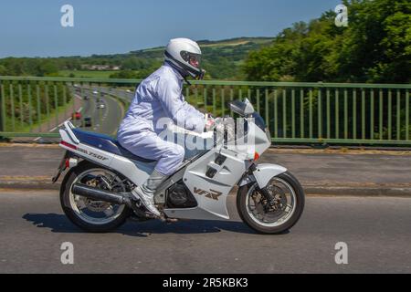 1986, 80s, Achtzigerjahre Honda VFR 750 F-G V4 (Zahnradgetriebene Nocken), VFR 750 F-G V vier weiße Motorräder Sportbenziner 748 cm3; Motorradfahrer trägt weißen Motorradfahranzug; zweirädriger Transport, Motorräder, Fahrzeug, Straßen, Motorräder, Motorradfahrer, die im Großraum Manchester, Großbritannien, unterwegs sind Stockfoto