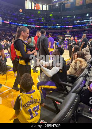 Los Angeles, USA. 22. Mai 2023. Basketball: NBA, Play-off Round, Western Conference, Conference Finals, Spieltag 4, Los Angeles Lakers – Denver Nuggets: NBA-Profi Dennis Schröder (r) spricht vor dem Spiel mit seiner Frau Ellen Schröder und seinen drei Kindern. Kredit: Maximilian Haupt/dpa/Alamy Live News Stockfoto