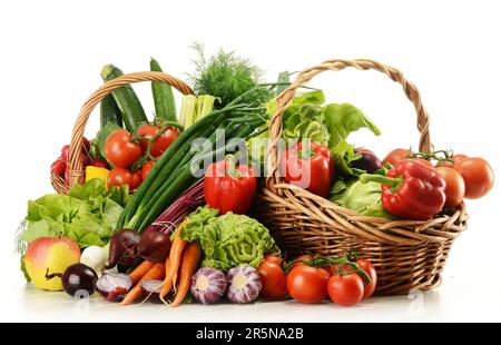Komposition mit rohem Gemüse und Weidenkorb isoliert auf weiss Stockfoto