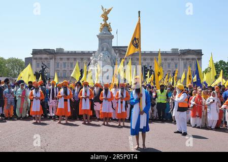 Sikhs begehen den 39. Jahrestag des Massakers am Goldenen Tempel, angeführt von Jüngern stehen vor dem Buckingham Palace, während sie in London marschieren. Stockfoto