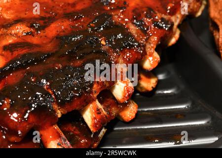 Gegrillte Spareribs in einem Kunststoffbehälter. Grillrippchen. Stockfoto