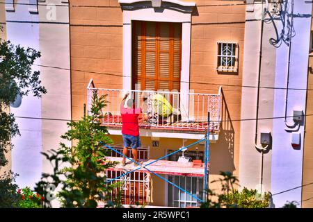 Barcelona, Spanien - August 17. 2014 : Konzentration auf eine sehr schöne Fassade in einer Wohnstraße, mit einem Mann, der auf einem Balkon arbeitet. Ein Freund von ihm ist Wächter Stockfoto