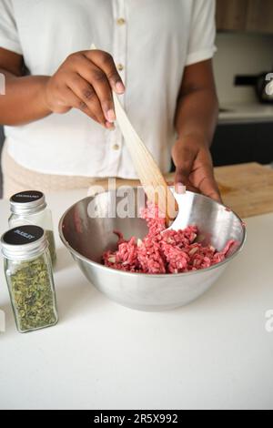 Nahaufnahme von kubanischen Frauen, die rohes Hackfleisch mit Knoblauch mischen. Stockfoto