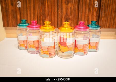 Bunte Glasbecher mit Deckel eignen sich perfekt zum Aufbewahren und Organisieren einer Vielzahl von Gegenständen. Mit ihren leuchtenden Farbtönen und ihrem praktischen Design bieten sie Stockfoto