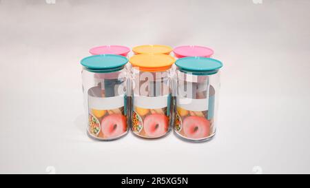 Die farbenfrohen Becher mit Deckel sind die perfekte Aufbewahrungslösung für alle, die ihrem Zuhause einen Hauch von Spaß und Stil verleihen möchten. Diese Gläser haben einen farbenfrohen Deckel Stockfoto