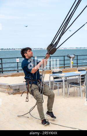 Nachbildung der spanischen Galeone aus dem 17. Jahrhundert am Southend Pier, Southend on Sea, Essex, Großbritannien. Ein Crewmitglied zieht an Seilen Stockfoto