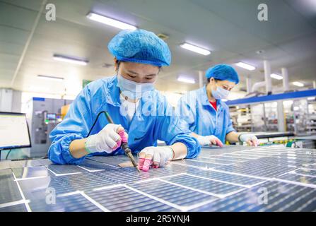 HAIAN, CHINA - 6. JUNI 2023 - Arbeiter stellen Solarmodule für den Export auf der Produktionslinie einer neuen Energiewerkstatt in Haian, Jiangsu, her Stockfoto