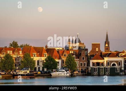 Holländische Stadt Haarlem bei Sonnenuntergang, Blick auf die Spaarne und den Turm des Stadttors Amsterdamse Poort Stockfoto