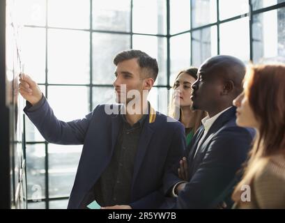 Junge, glückliche, multiethnische, vielfältige, junge, professionelle, kreative Teamschüler, die Brainstorming führen Stockfoto