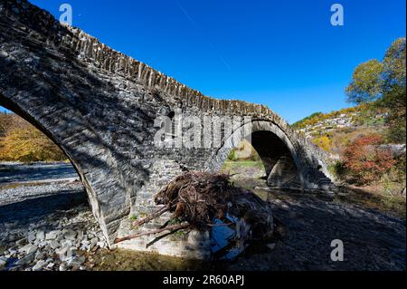 Blick auf die traditionelle Steinbrücke Mylos in Epirus, Griechenland im Herbst Stockfoto