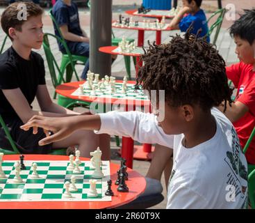 Washington, DC: Kinder spielen Schach auf der Eastern Market Metro Plaza am Capitol Hill. Das Schachturnier wurde von den USA organisiert Schachzentrum. Stockfoto