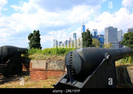 10- und 15-Zoll-Rodman-Artilleriekanonen von 1861, die Fort Jay auf Governors Island bewachen, mit Lower Manhattan und der Skyline von New Jersey City im Hintergrund Stockfoto