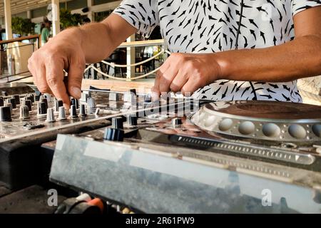 Türkei, Alanya - 12. August 2022: DJ spielt auf dj-Konsolenmixer am Strand, Hände und Drehteller Nahaufnahme Stockfoto