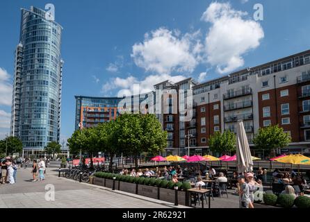 Gunwharf Quays in Portsmouth, Hampshire, England, an einem geschäftigen Samstagnachmittag im Juni, mit Menschen, die sich entspannen und die Cafés im Freien genießen Stockfoto