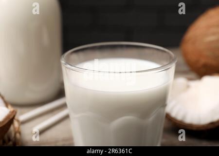 Ein Glas frische Kokosmilch auf dem Tisch, Nahaufnahme Stockfoto