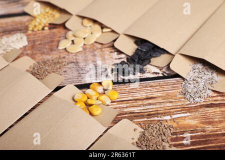 Viele verschiedene Gemüsesamen auf Holztisch, Nahaufnahme Stockfoto