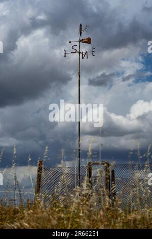 Pinwheel mit den Initialen der Kardinalpunkte an einem bewölkten Tag. Stockfoto