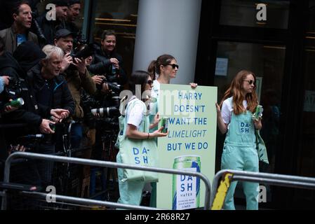 Marketingfachleute halten ein Plakat und verteilen Getränke an die Presse, vor den königlichen Gerichtshöfen, dem britischen High Court während des Gerichtsverfahrens gegen Prinz Harry, Herzog von Sussex. Prinz Harry hat einen Zeugenstand als Teil der Ansprüche gegen einen britischen Boulevardverleger, den letzten seiner Rechtsstreitigkeiten mit der Presse. König Karls jüngerer Sohn wird der erste ranghöchste britische königliche König sein, der seit mehr als einem Jahrhundert vor Gericht aussagt, wenn er gegen Mirror Group Newspapers (MGN) aussagt. (Foto: Loredana Sangiuliano/SOPA Images/Sipa USA) Stockfoto