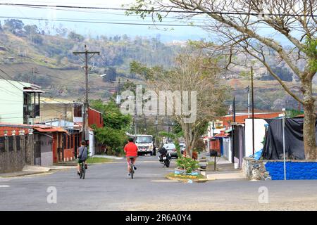 März 3 2023 - Orosi in Costa Rica: Straßenblick auf eine kleine Stadt mit Menschen, die auf den engen Gassen der Nachbarschaft spazieren und ihr Leben leben Stockfoto