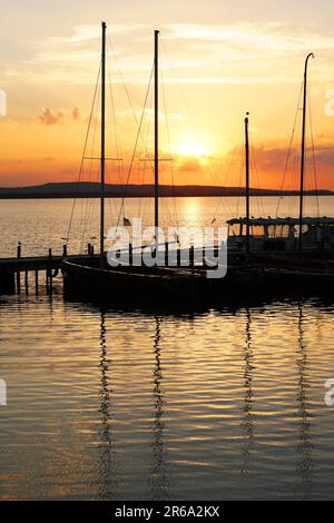 Segelboot Boote im Marina Pier bei Sonnenuntergang Sonnenuntergang günstig über den See Steinhuder Meer in Deutschland in Silhouette Stockfoto