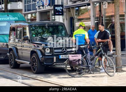 8. Juni 2023, München, Bayern, Deutschland: Ein Mitglied der Münchner Fahrradstaffel (Fahrradpolizei) kümmert sich um das illegale Parken auf Bürgersteigen im Bezirk Pasing. Zu jeder Zeit, insbesondere vor den türkischen Friseurgeschäften, stehen zahlreiche Autos illegal auf Gehwegen, die Fußgänger behindern und Unternehmen blockieren. Wenn ein Ticketaussteller oder Beamter vor Ort eintrifft, um Tickets zu schreiben, werden sie in der Regel von manchmal großen Gruppen von Männern überschwemmt, die aggressiv „erklären“. Die Bürger betrachten dies als Gesetzlosigkeit und mangelnde Achtung der Normen und Gesetze der deutschen Gesellschaft mit CRI Stockfoto