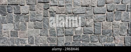 Struktur von Pflastersteinen. Kopfsteinpflaster, Draufsicht. Ein alter Steinweg. Einbaustruktur. Kopfsteinpflastersteinpflasterstruktur. Kopfsteinpflaster Stockfoto