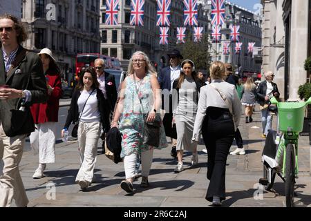 Straßenszene mit Touristen, die an einem heißen Sommertag am 2023. Juni die Regent Street im Londoner West End entlang laufen. Stockfoto