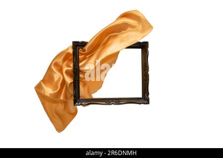 Goldenes satiniertes Tuch, das durch einen Holzrahmen fliegt, Bewegungsunschärfe, das Produkt enthüllt, abstrakter Hintergrund. Stockfoto