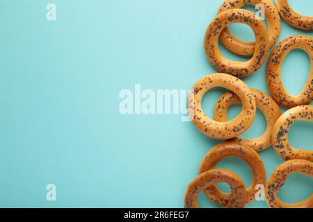 Ganzer Bagel mit Mohnsamen auf blauem Hintergrund. Draufsicht Stockfoto