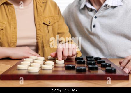 Dame spielen. Senior-Mann, lernende Frau am Tisch im Raum, Nahaufnahme Stockfoto