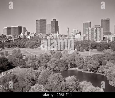 1970S BOSTON GEMEINSAMER ÖFFENTLICHER GARTEN ERSTER BOTANISCHER GARTEN IN AMERIKA REGIERUNGSGEBÄUDE LINKS UND FINANZVIERTEL RECHTS MA USA - R24399 KRU001 HARS IMMOBILIENSTRUKTUREN STÄDTE USA BAUWERK LINKS MA NEW ENGLAND SCHWARZ-WEISS BOTANISCHER BEZIRK ALTMODISCH Stockfoto