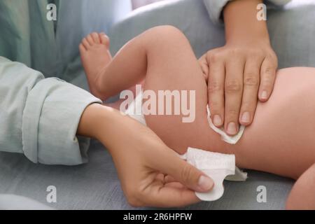 Mutter, die die Windel des Babys wechselt, auf dem Tisch, Nahaufnahme Stockfoto