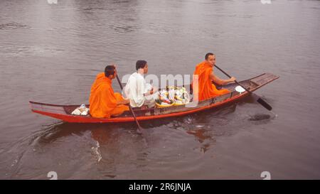 Buddhistische Mönche in einem Kanu in der Stadt Nakhon Pathom in der Provinz Nakhon Pathom, Thailand. Stockfoto